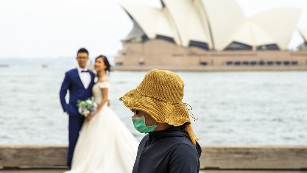 Coronavirus spreads to Sydney - masked person interrupts wedding photo